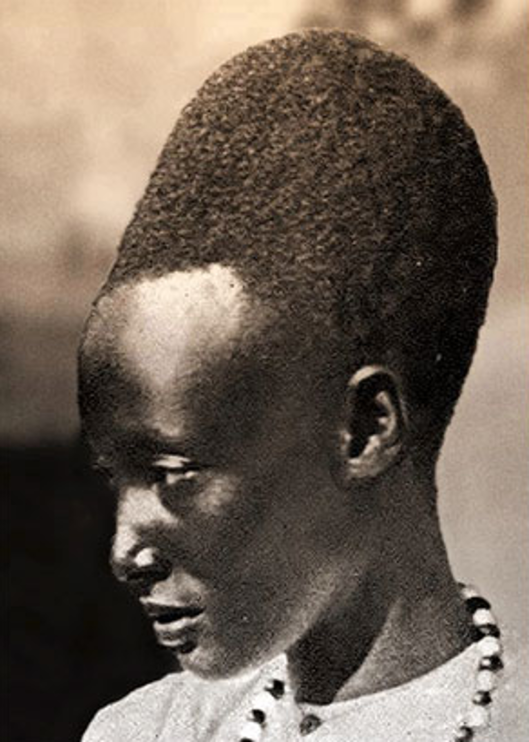 A Tutsi Bantu woman with another variation of the amasunzu hairstyle.