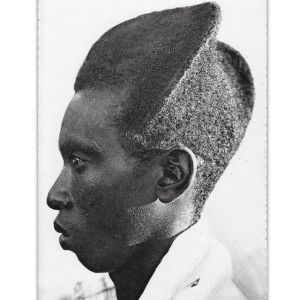 A Tutsi Bantu man with a variation of the Amasunzu hairstyle. It has been conjectured by some writers that this coiffure was meant to emulate the Khepresh or Blue Crown of ancient Egypt.