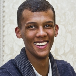 The singer Stromae, born to Tutsi Bantu and European parents. In physiognomy, he is intermediate between Bantu and European peoples, with a slightly greater pull toward the latter. This is due to the fact that his Tutsi parent already bears some Eurasian admixture (~20%), which was derived from earlier Cushitic peoples whom the Tutsi-Hima's Bantu ancestors absorbed. Stromae would therefore have inherited around 10% of that foreign admixture, resulting in a more "Caucasoid"-leaning physiognomy than is typical among mixed Bantu-European individuals.